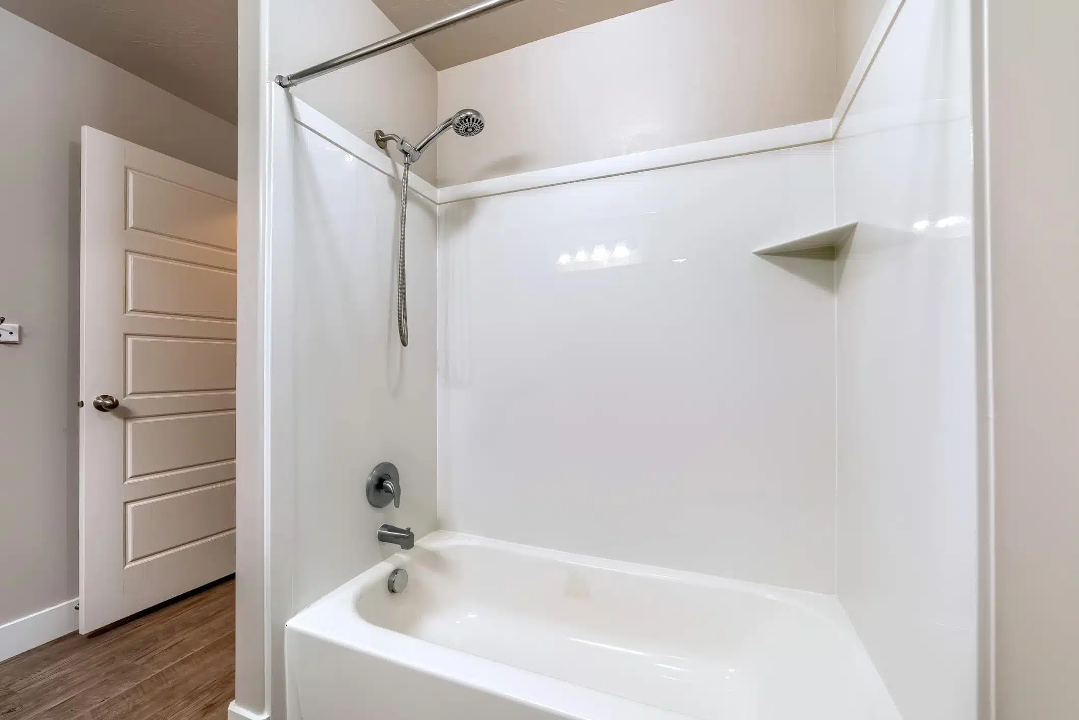 image of a white bathtub that is slippery and before a non slip product from Slip No More is applied